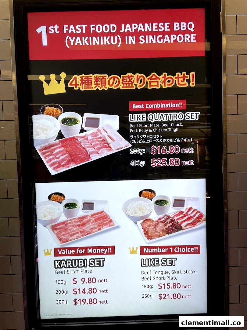 A brightly lit menu board showcasing various Japanese BBQ yakiniku sets with prices.