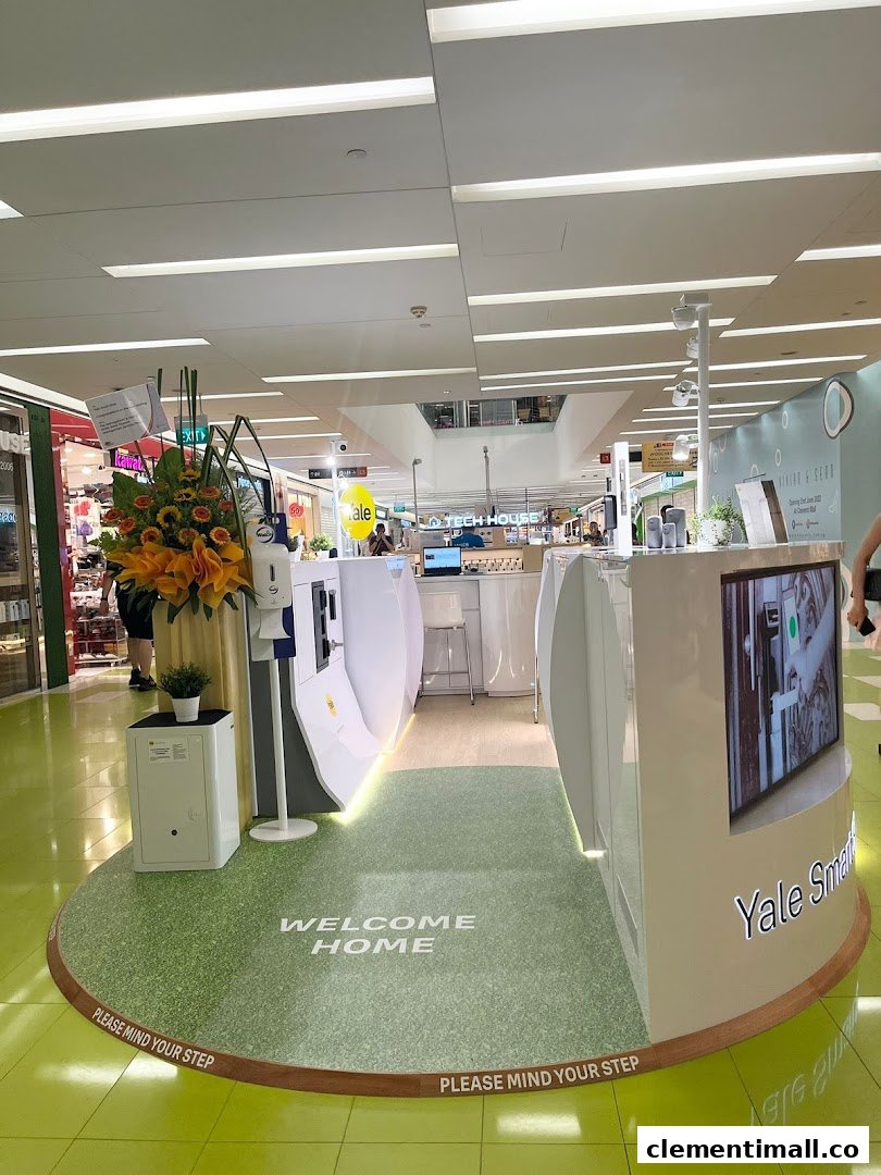 An interior view of the Yale Smart Shop display, showcasing smart home security products and a 'Welcome Home' mat.