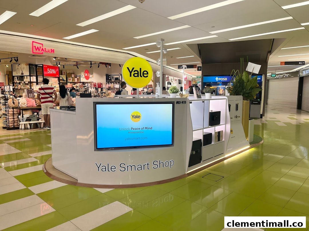 A modern Yale Smart Shop kiosk showcasing smart home security products and a digital display in a bustling mall.