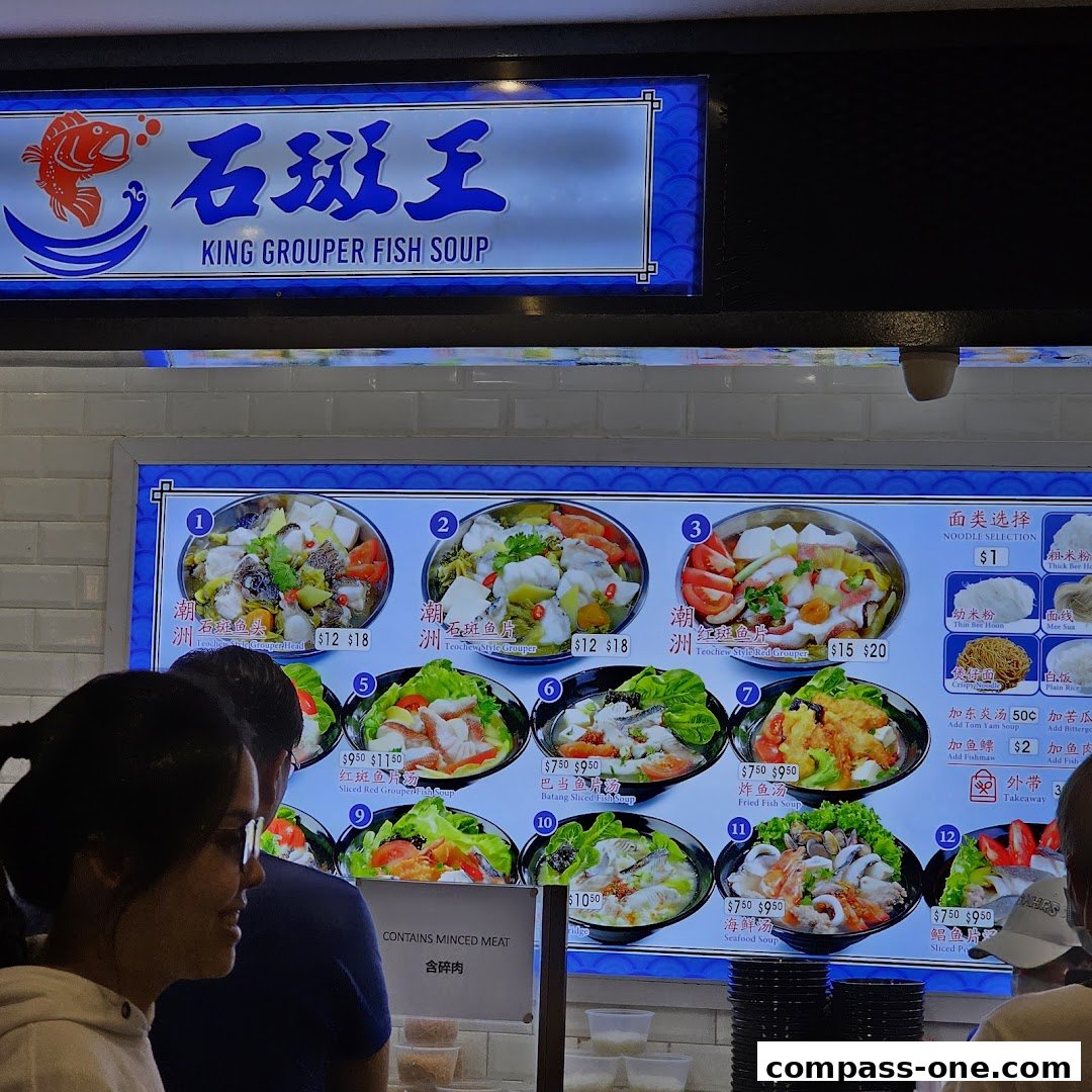 A menu board for King Grouper Fish Soup with various fish soup dishes and noodle selections.