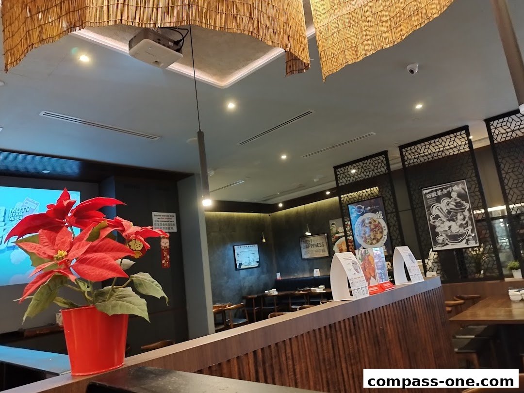 Interior view of Fu Qi Grilled Fish restaurant with seating and decorative elements.