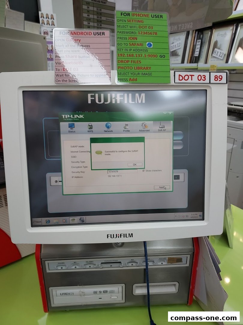 A computer setup for photo transfer with instructions for Android and iPhone users.