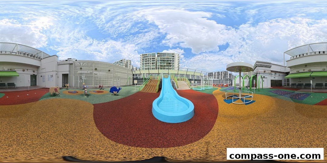 A vibrant outdoor playground with slides, swings, and climbing structures under a cloudy sky.