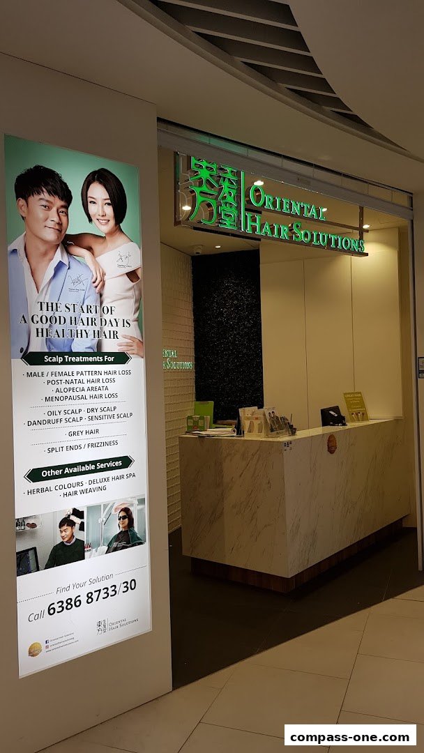 The entrance of Oriental Hair Solutions with a display of services and contact information.