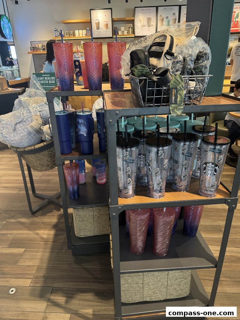 Starbucks store interior displaying various merchandise, including tumblers and bags.