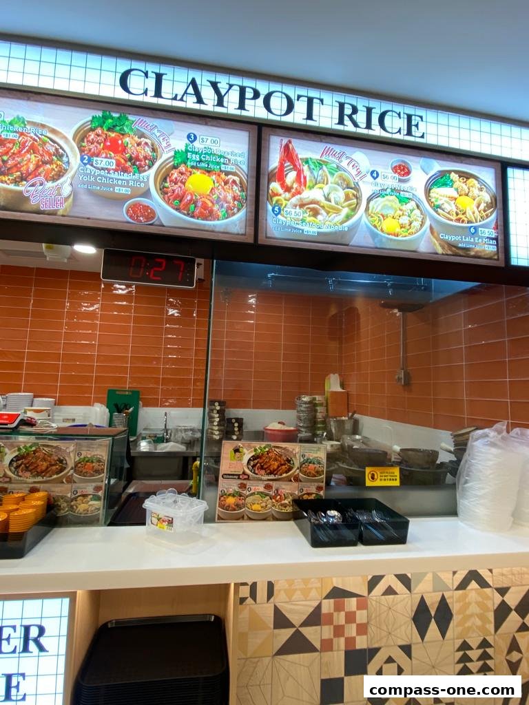 A display of claypot rice dishes with prices and descriptions at Encik Tan.