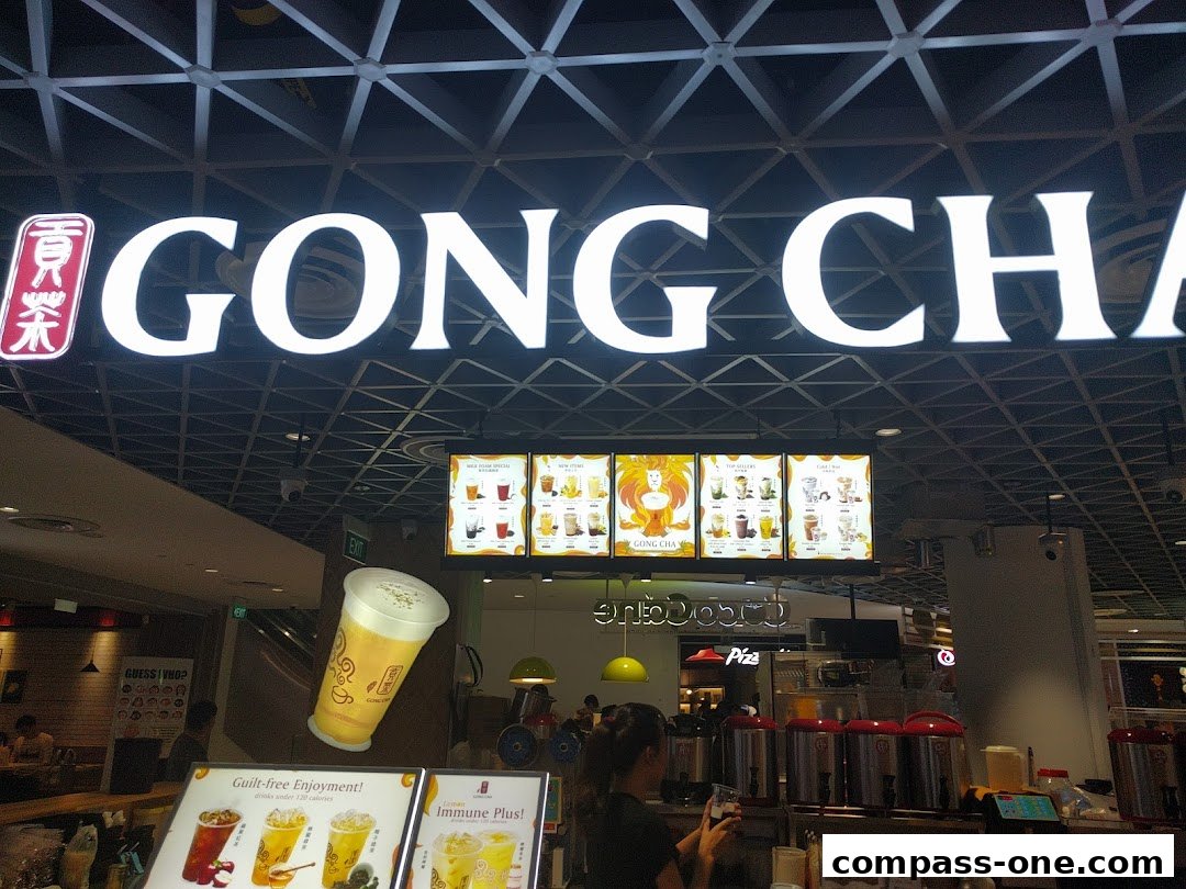 The Gong Cha shop front with illuminated signage and a display of drinks.