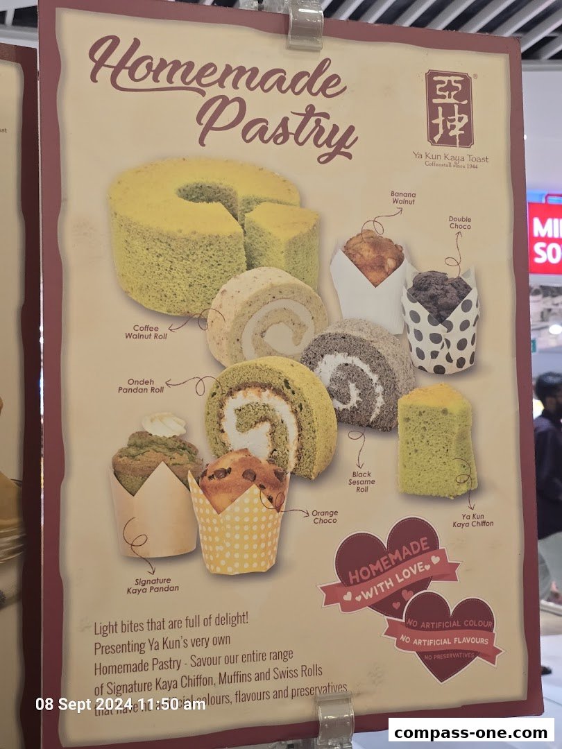 A display board showcasing various homemade pastries from Ya Kun Kaya Toast.