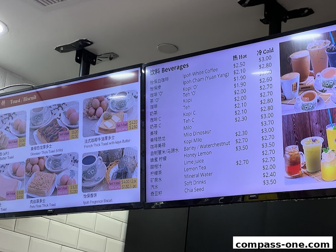 A digital menu board displaying various Ipoh delicacies and beverages with prices.