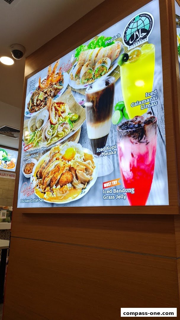 A brightly lit menu board showcasing various dishes and drinks from Encik Tan.
