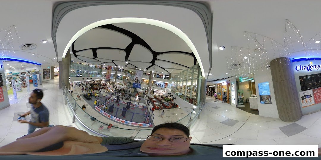 A panoramic view of a busy shopping mall with the Challenger store visible.