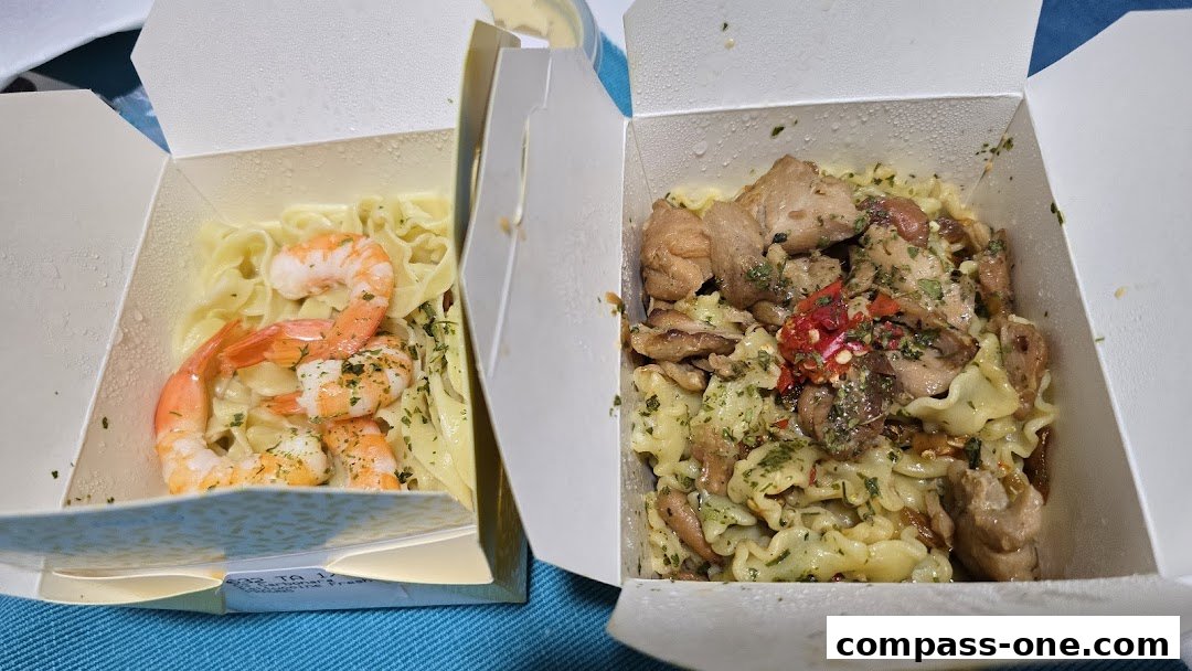 Two takeaway boxes filled with fresh pasta dishes, one with shrimp and the other with chicken.