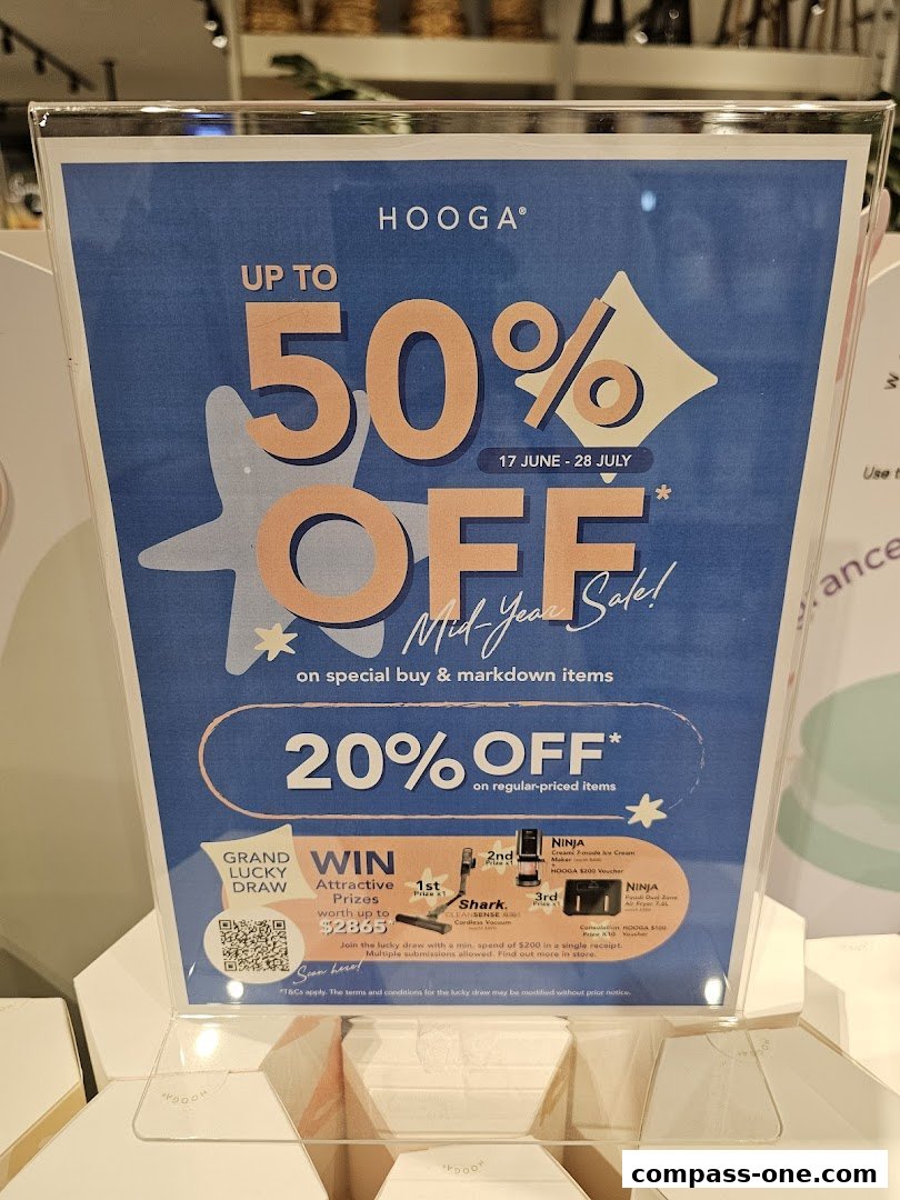 A sign advertising HOOGA's Mid-Year Sale with up to 50% off and a lucky draw.