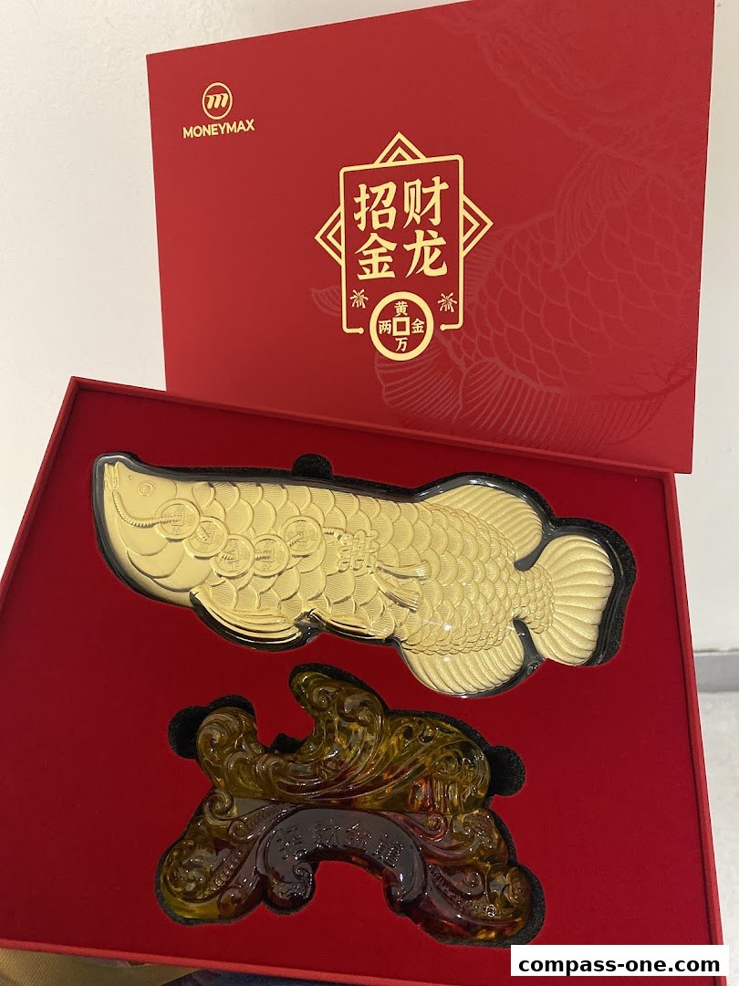 A golden fish ornament with Chinese characters on a red box.