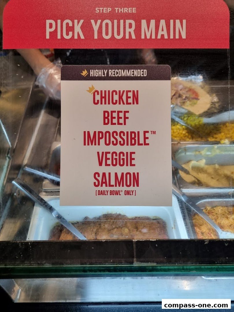 A sign displays options for picking a main course, including chicken, beef, and salmon.
