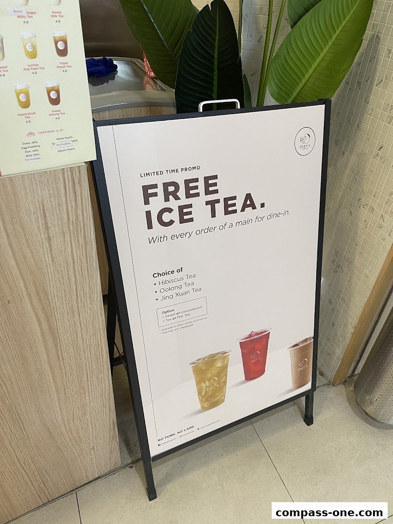 A-frame sign advertising a free ice tea promotion at Zoeys.