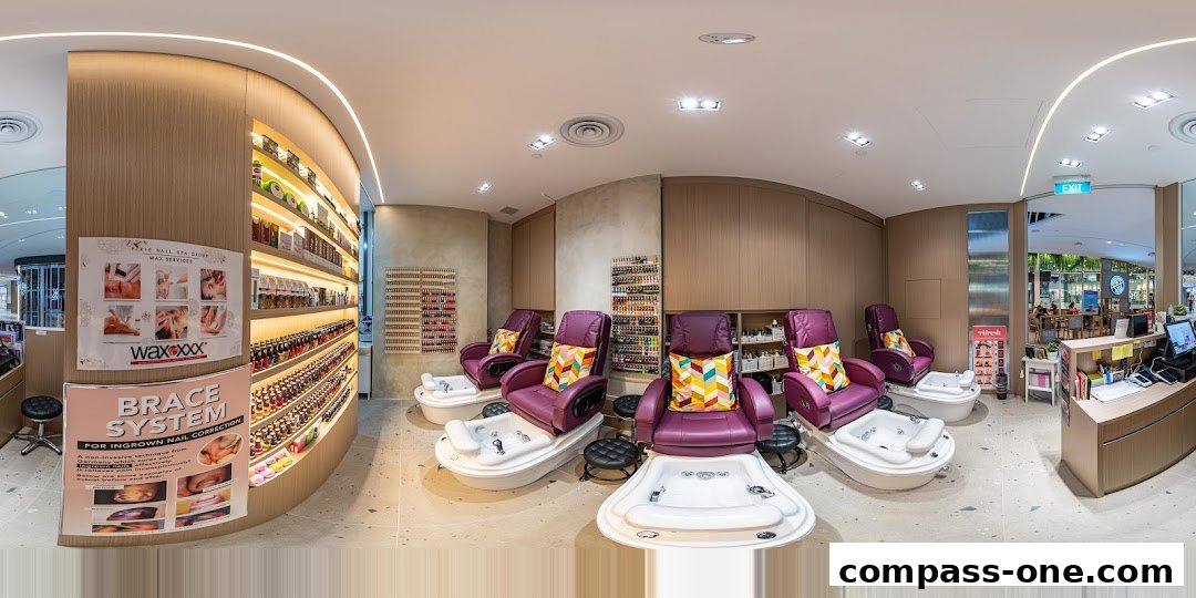Interior of a nail spa with pedicure chairs, nail polish displays, and a reception counter.