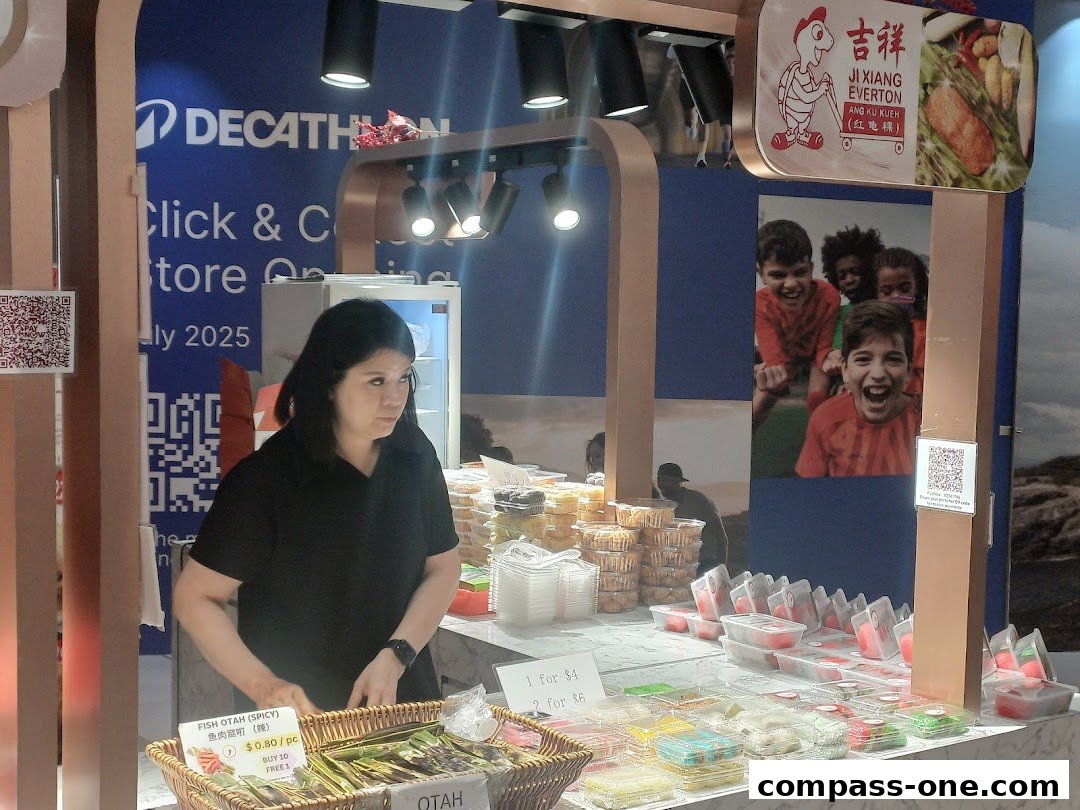 A vendor stands behind a counter displaying various traditional snacks and food items.