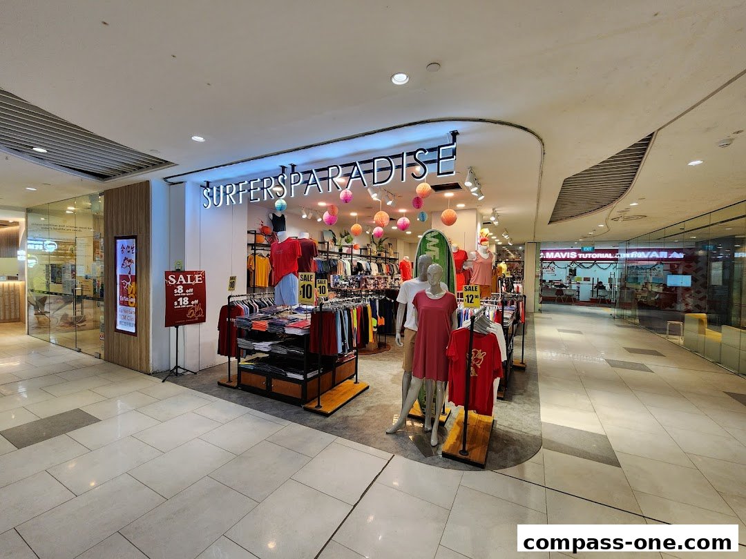 The Surfers Paradise shop displays clothing on racks and mannequins, with sale signs outside.