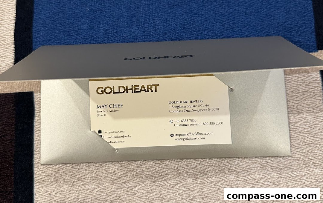 A Goldheart jewelry business card with contact information and website details.