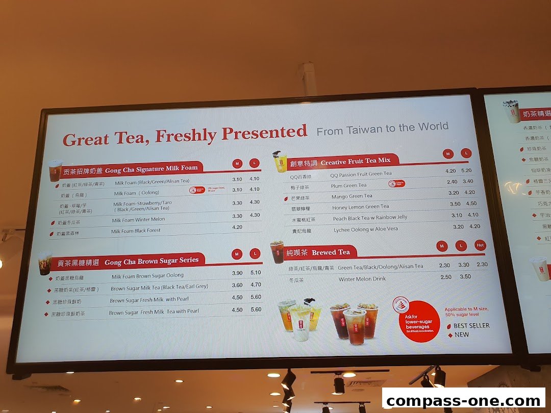 A digital menu board displaying various milk tea and fruit tea options from Gong Cha.