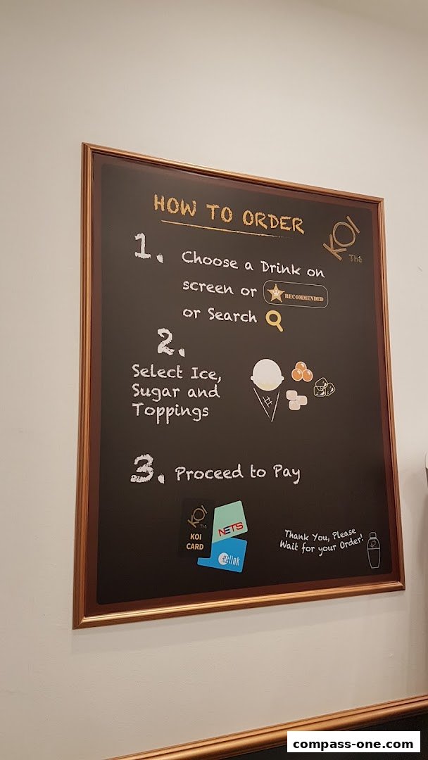 A chalkboard sign at KOI Thé explaining the ordering process with illustrations.