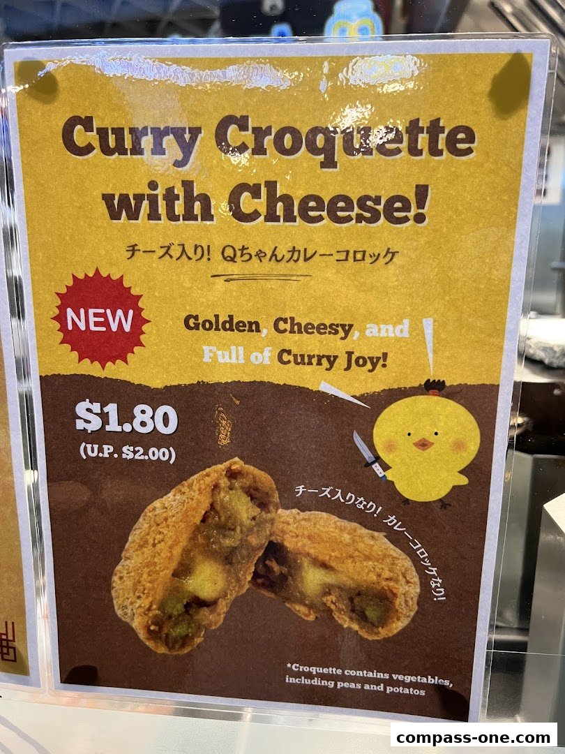 A sign advertising a new Curry Croquette with Cheese, priced at $1.80.