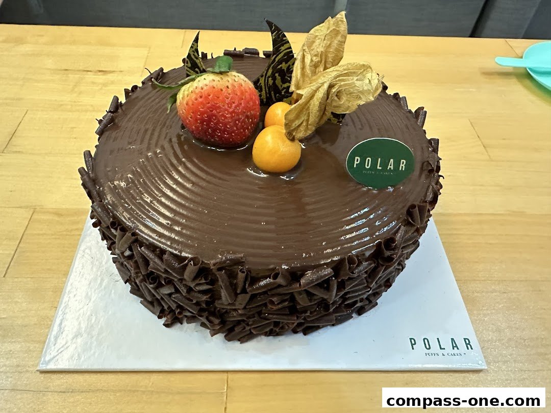 A decadent chocolate cake topped with fresh strawberry and physalis.