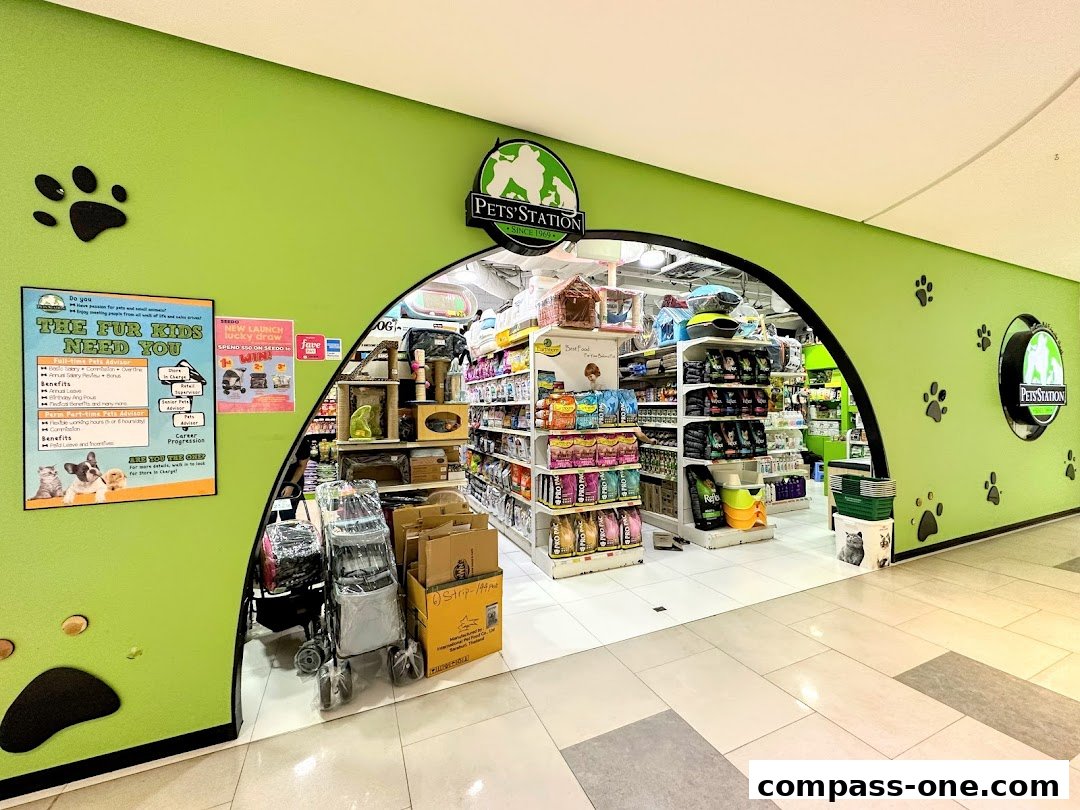 The entrance to Pets Station, a pet supply store, showcasing shelves stocked with pet food and accessories.