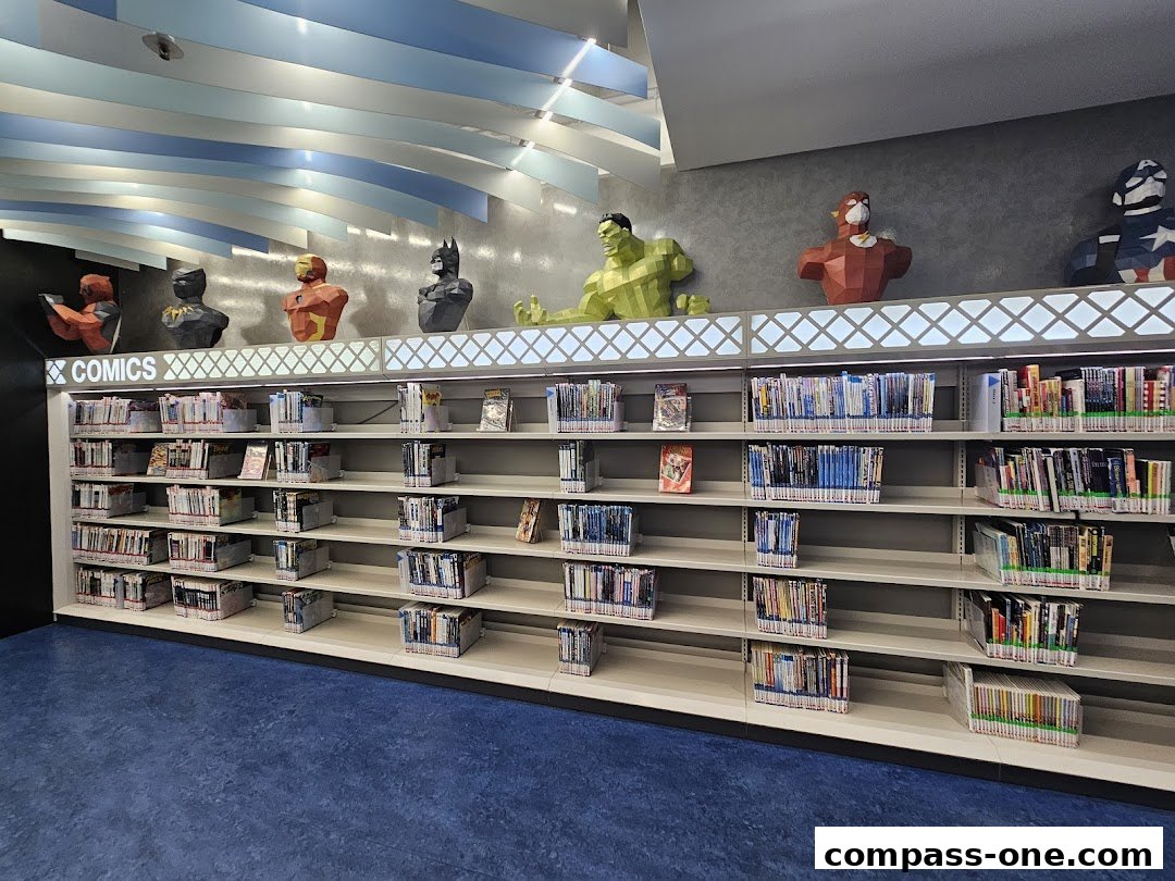 Library shelves filled with comics and books, featuring superhero busts on top.