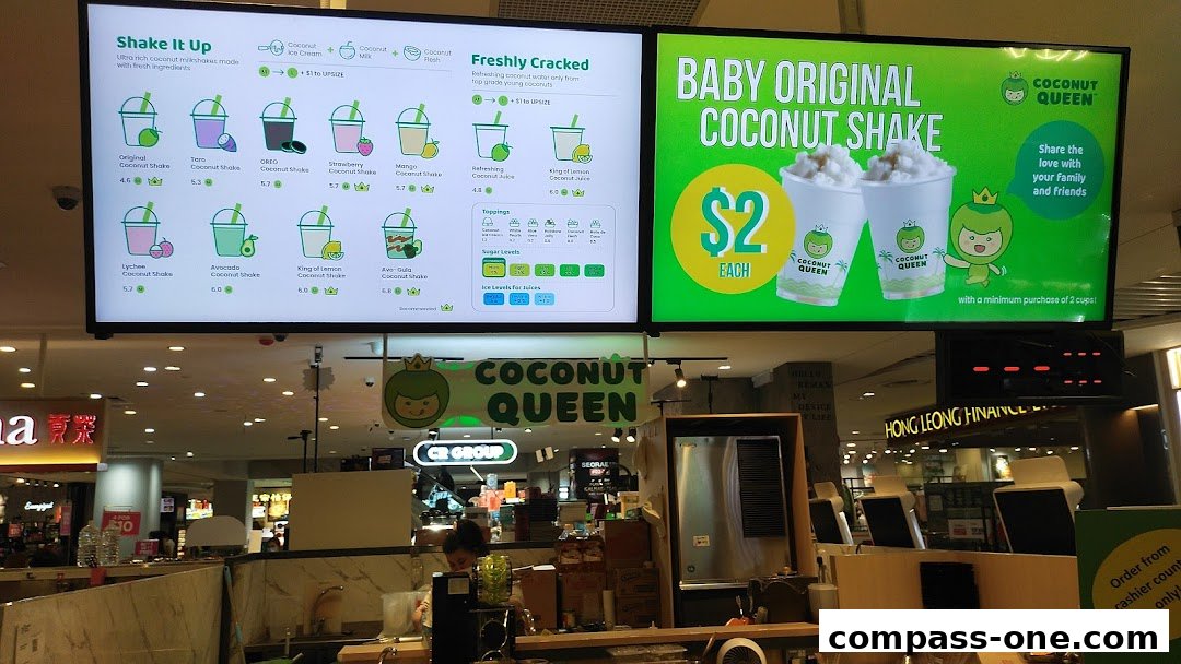 A digital menu board displaying various coconut shakes and juices from Coconut Queen.