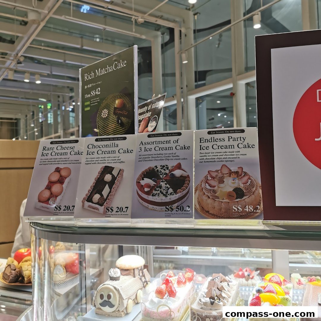 Display of various ice cream cakes with descriptions and prices.