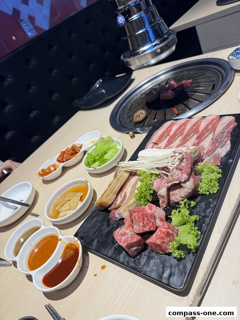 A platter of raw Korean BBQ meats and side dishes, ready for grilling.