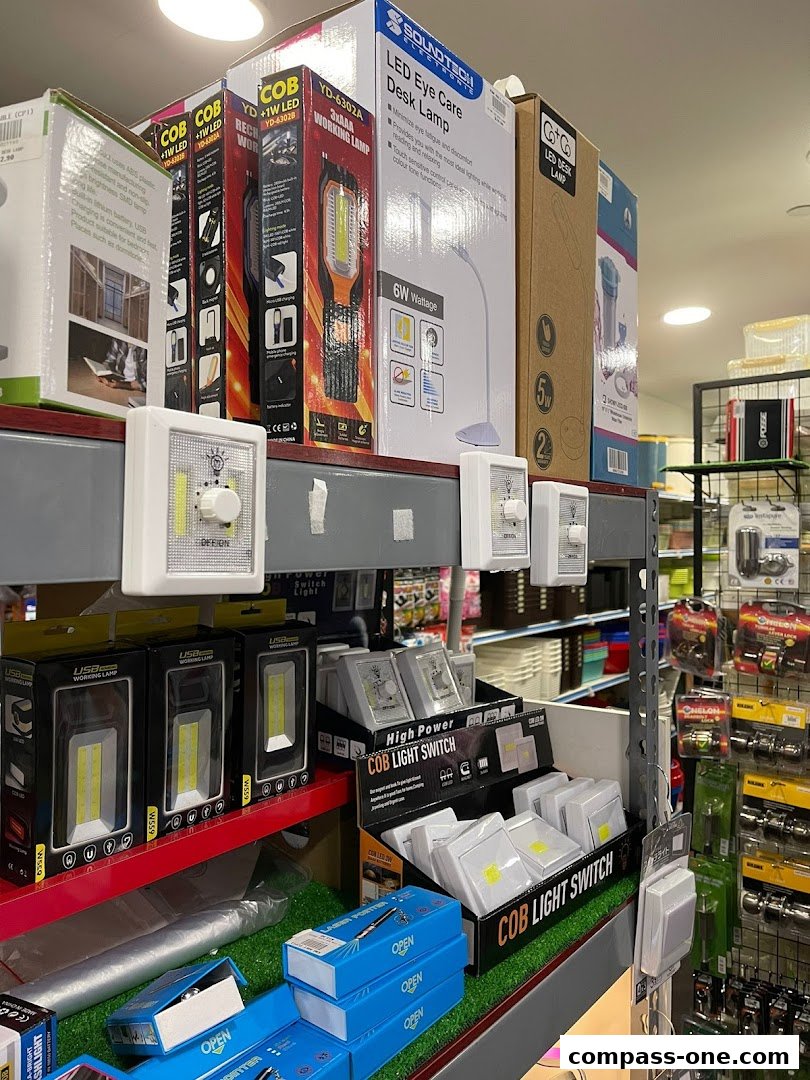 Shelves stocked with various LED lights, desk lamps, and switches for sale.