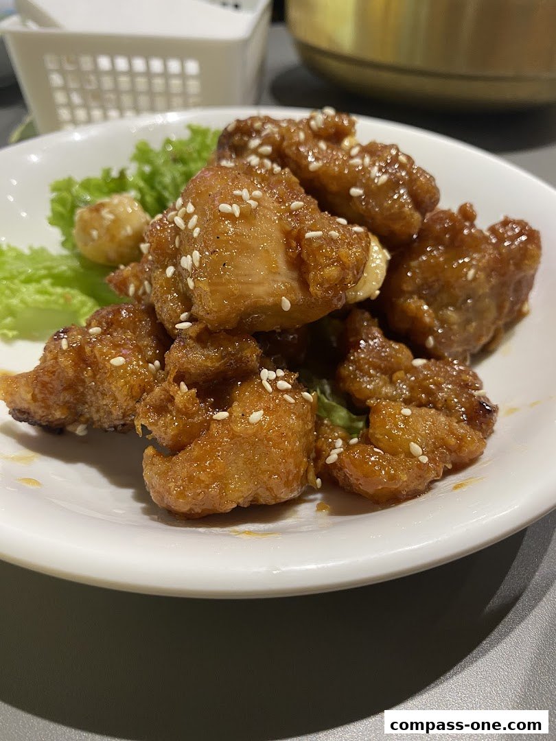 A close-up shot of delicious Korean fried chicken with sesame seeds.