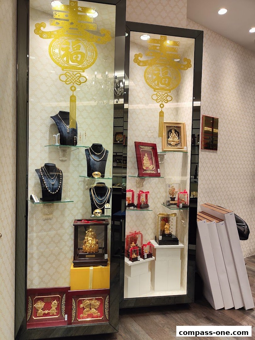 A jewelry shop display featuring gold necklaces, statues, and decorative items.
