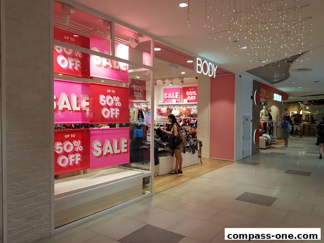 The Body Shop storefront with prominent 'Up to 50% Off' sale signs.
