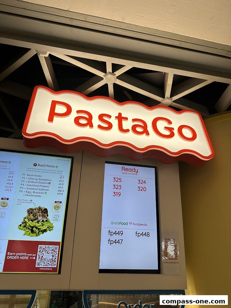 A digital menu board displaying pasta options and prices, with order codes.
