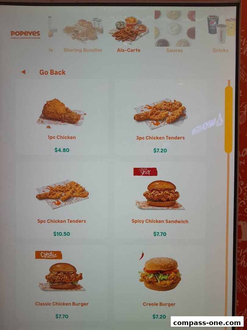 A digital menu displaying various Popeyes chicken and burger options with prices.