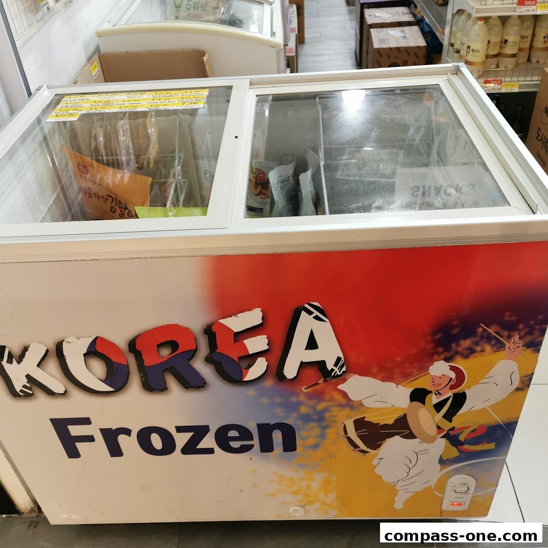 A chest freezer with 'KOREA Frozen' branding and a graphic of a person playing a drum.