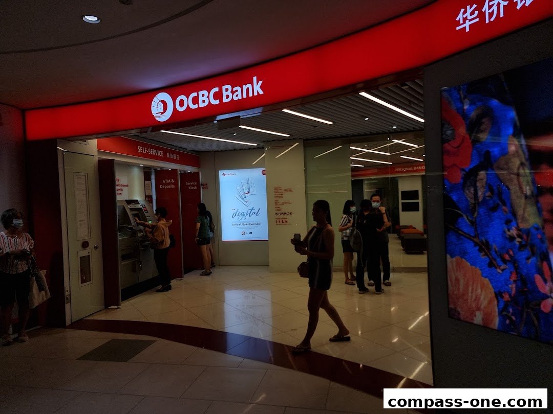OCBC Bank branch with self-service kiosks and people using ATMs.