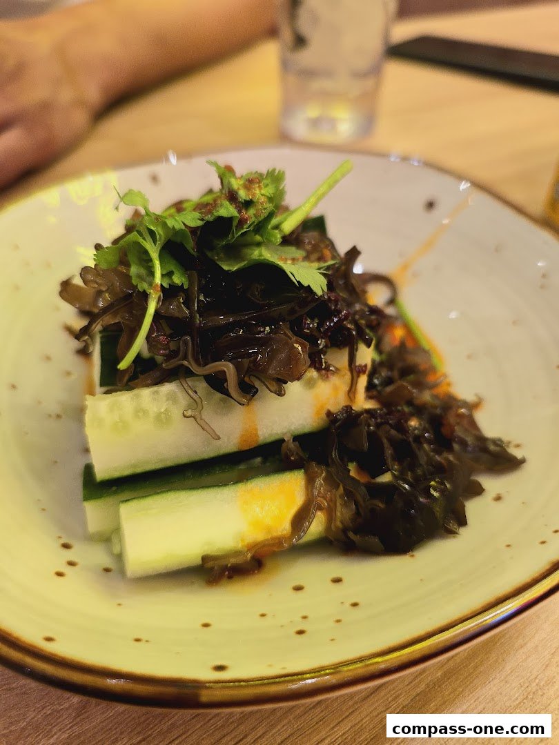 A close-up of a refreshing cucumber salad with wood ear mushrooms and cilantro.