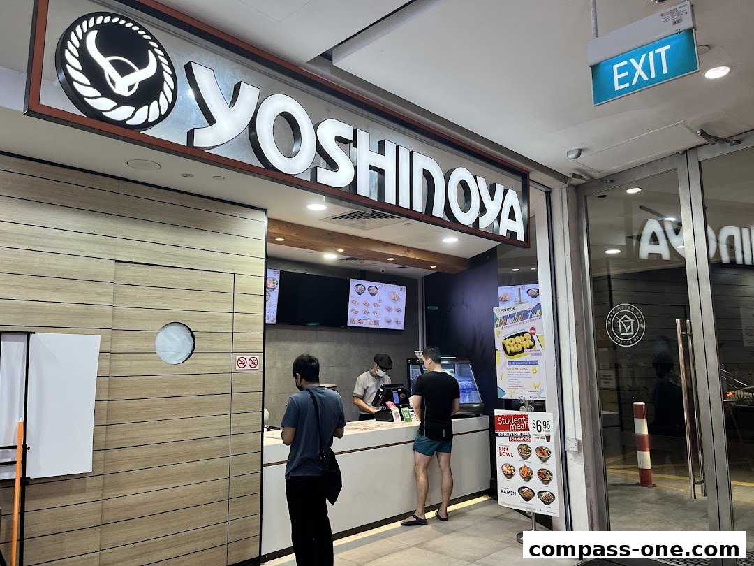 The Yoshinoya restaurant entrance with customers ordering at the counter.
