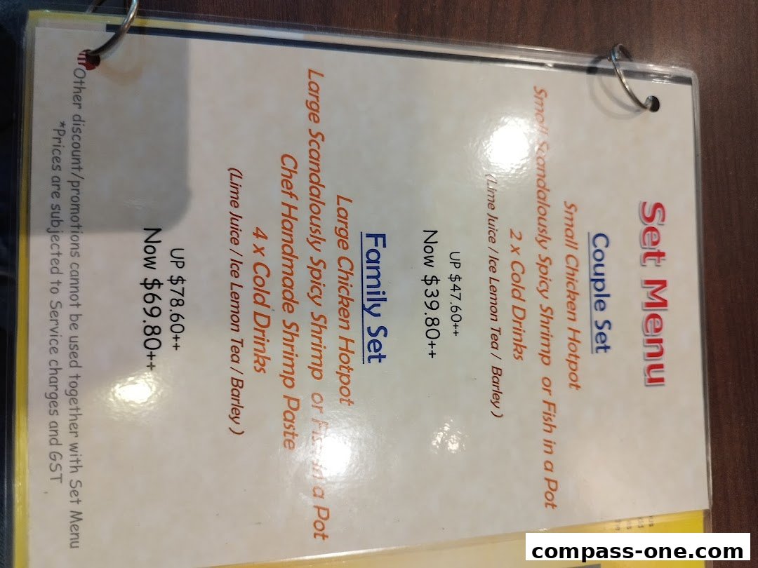 A menu for Chicken Hotpot Compass One, featuring set menus for couples and families.