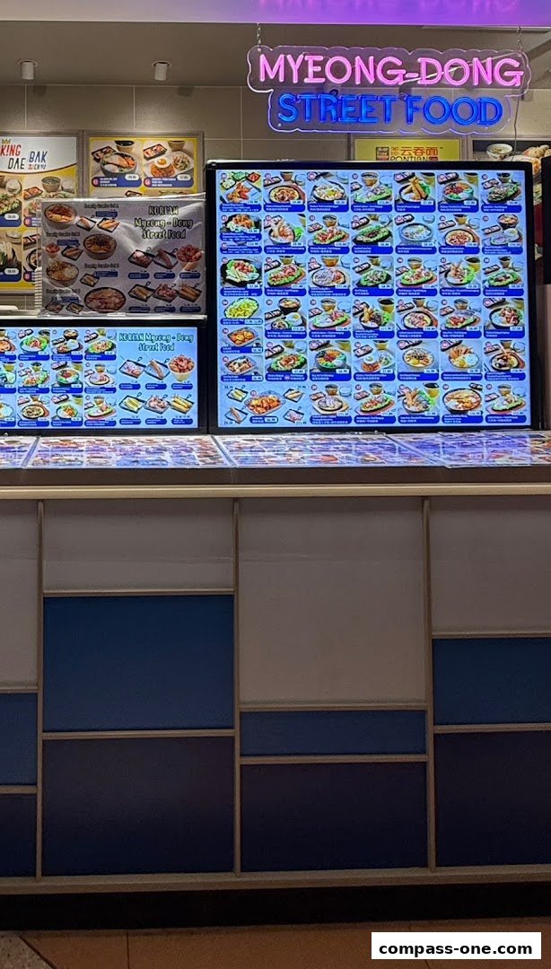 Digital menu boards displaying various Korean street food dishes with images and prices.