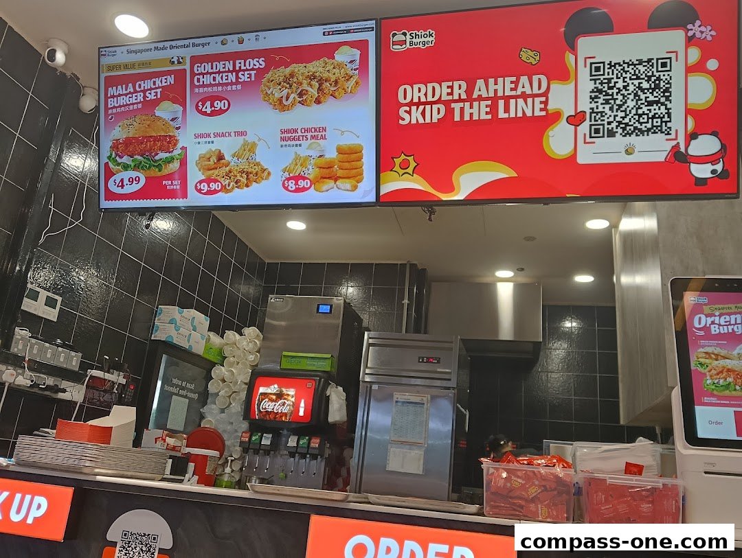 A digital menu board displaying various burger and chicken set meals with prices.
