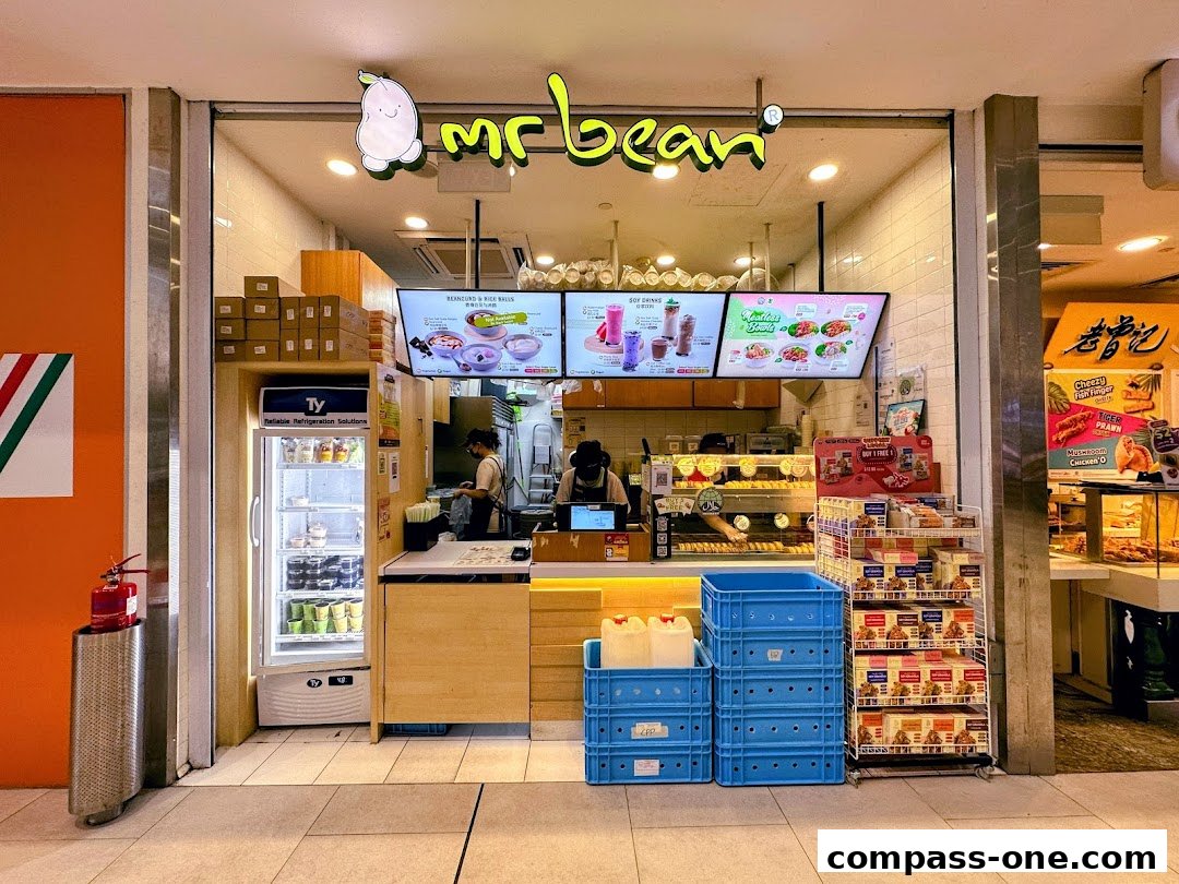 The Mr Bean shop front displays a menu board, a refrigerator, and a counter with food items.