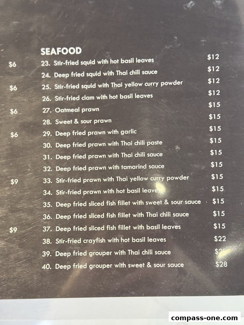 A menu section for Seafood dishes at Nakhon Kitchen, listing various preparations of squid, prawns, fish, and crayfish.