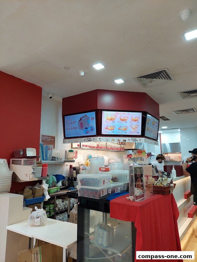 Interior view of Ya Kun Kaya Toast with digital menus and food preparation area.