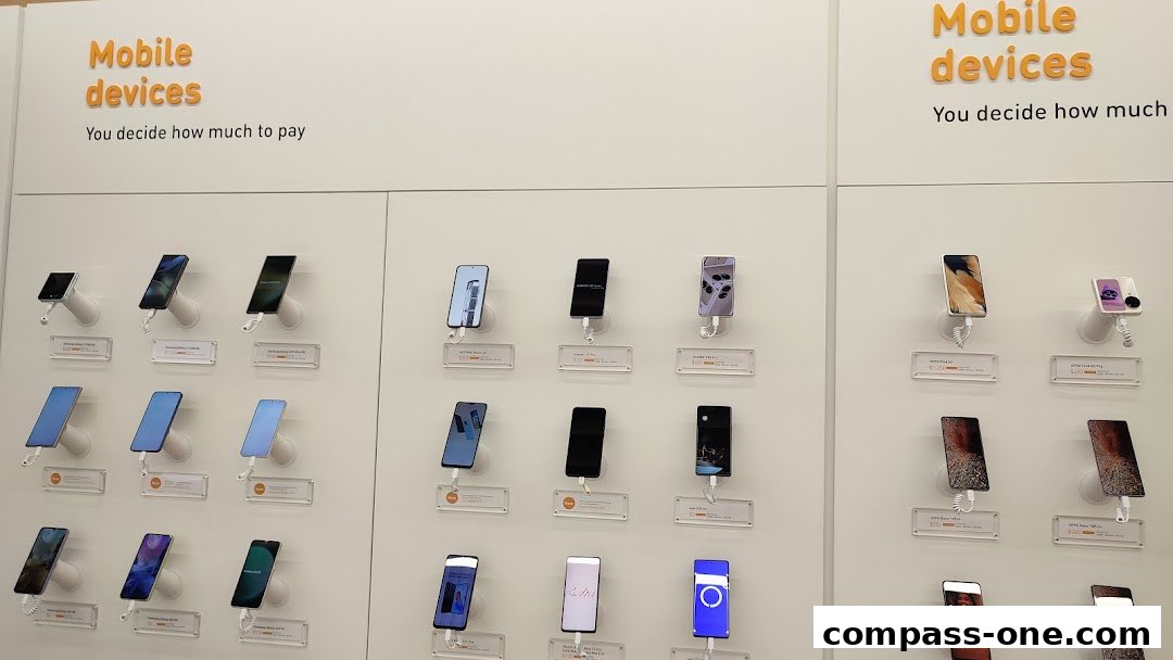 A display wall showcasing various mobile phones with labels indicating brands and prices.